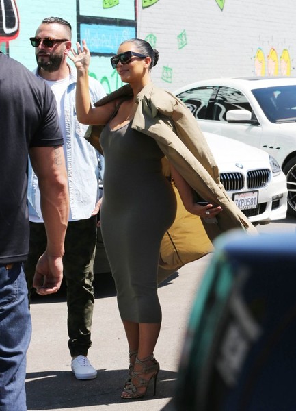 Pregnant Kim Kardashian waves
